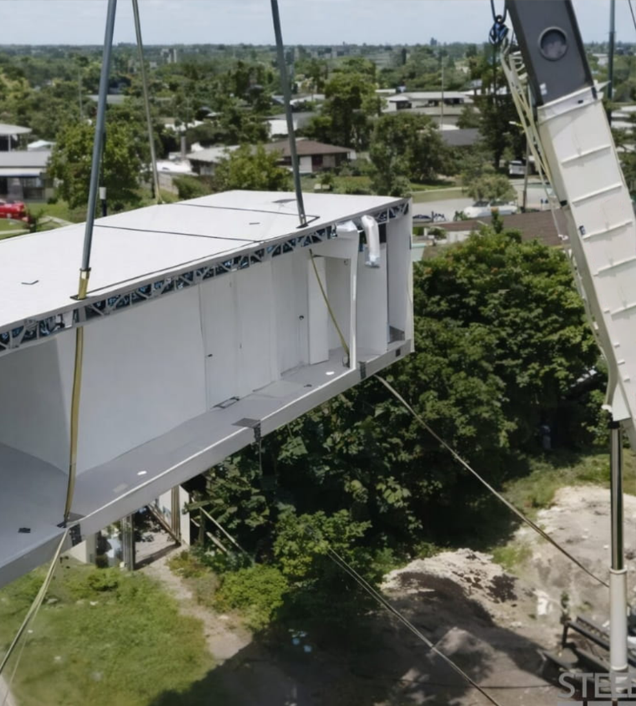 Crane Delivering a Steel Home on the site